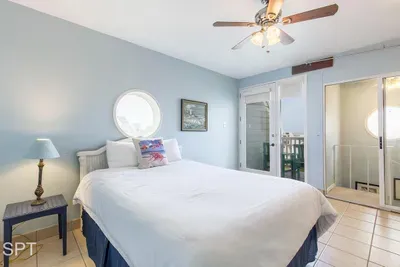 Serene Beach‑House Bedroom — Soft Blue Walls, Round Window & A Peaceful Retreat with Natural Light