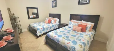 A warm, easygoing room designed for unwinding, with twin beds dressed in bright coastal patterns and a calm, tidy layout that feels instantly welcoming. A simple setup that keeps the vibe relaxed and lets guests settle in comfortably.