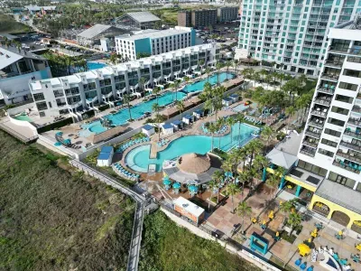 A wide, inviting resort setting with pools, palms & open walkways that create an easy, vacation‑ready atmosphere. The layout feels lively yet relaxed, offering a bright sense of space that sets the tone for a carefree stay from the moment you arrive.