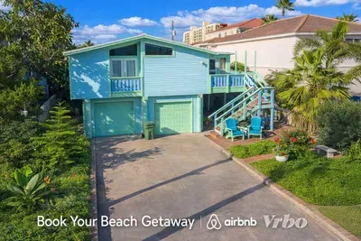Bright Coastal Retreat | 2BR Elevated Home w/ Balcony, Garage, Tropical Garden | Walk to Beach & Dining