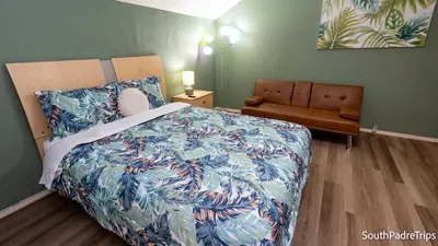 Calm, tropical‑themed retreat with soft green tones and leafy prints that set an easy island rhythm. Settle into this bright, welcoming space where relaxed décor and warm textures create a peaceful South Padre escape made for unwinding.