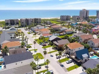 This property is on the LEFT side of this picture with orange room. You can see it is less than 1/2 a block to the beach