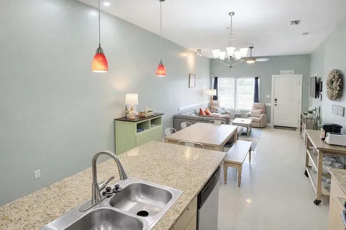 Modern Coastal Retreat: Open-Concept Living, Granite Kitchen Island, Cozy Dining Nook, Plush Sofa, Smart TV, Natural Light, Steps to Beach & Dining