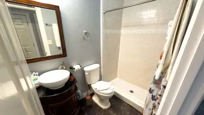 A simple, well‑kept bathroom with soft tones and a clean, grounded feel, offering a quiet pause between busy moments. Its tidy layout and relaxed mood create an easy flow that keeps the stay feeling smooth, comfortable, and unhurried.