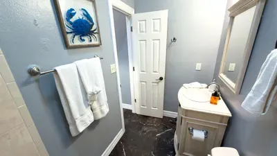 A clean, easygoing bathroom with soft tones and a simple coastal touch, offering a quiet moment to reset between busy days. Its relaxed feel and tidy layout create a sense of ease that keeps the stay feeling smooth and unhurried.
