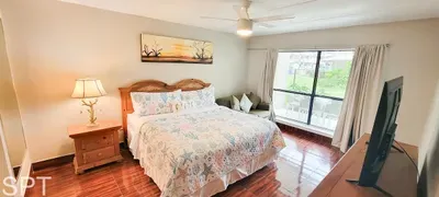 Warm, inviting bedroom with a calm, grounded feel—soft light, natural tones, and simple décor create an easy space to unwind after a full day. A genuine, restful setting that feels comfortable and unforced, without leaning on amenities.