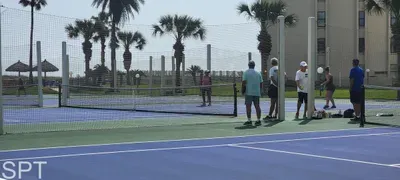 Steady, open court setting with a relaxed coastal backdrop—easy energy, natural light, and a simple flow that makes time outside feel unhurried. A genuine, down‑to‑earth space that fits effortlessly into a beachside stay without leaning on amenities.