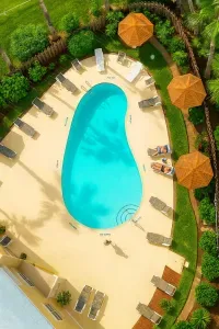 Tropical Paradise Poolside Retreat w/ Loungers & Palms. Dive into bliss at this stunning turquoise pool oasis surrounded by swaying palms, thatched umbrellas, and plush loungers. Perfect for sun-soaked relaxation amid lush tropical gardens.