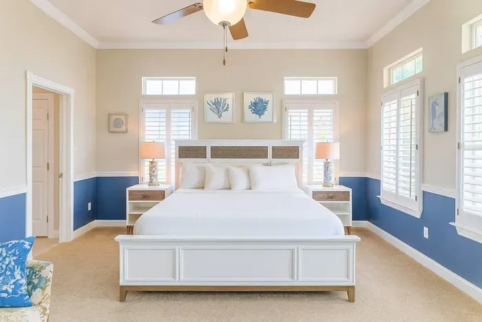 Relax in this bright, spacious bedroom featuring a comfortable bed, ample natural light, beach-inspired décor. Enjoy peaceful mornings with sunlight streaming through large windows—perfect for unwinding after a sun-filled day on South Padre Island.