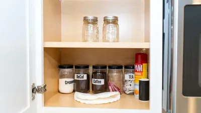 Well-Stocked Pantry
Coffee, Creamer & Essentials Galore. Open white cabinet brims w/ labeled jars of decaf, coffee, tea, cream, spray & sponges beside SS fridge. Thoughtful touches for easy mornings—start your beach day fueled & happy!