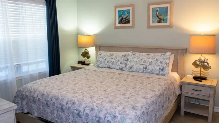 Tranquil Coastal Bedroom
Comfy Bed & Seagull Art Glow. Soft seafoam walls, driftwood frame w/ floral duvet, brass lamps & pelican prints create serene retreat. Sheer curtains filter light—drift to sleep w/ ocean dreams in beachy elegance!