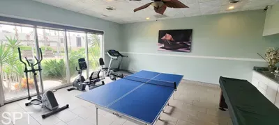 Game & Fitness Room with Natural Light
Spacious recreation room featuring a ping‑pong table, covered pool table, and cardio equipment—perfect for workouts, friendly games, and enjoying a bright indoor activity space.