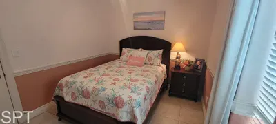 Cozy, well‑styled bedroom featuring a vibrant patterned bedspread, warm lighting, framed artwork, and thoughtful décor—creating a welcoming retreat perfect for restful nights, relaxed mornings, and a comfortable stay throughout.