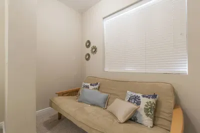 Cozy Flex Room • Comfy Futon with Accent Pillows & Soft Lighting • Perfect as a Relaxing Lounge or Extra Sleeping Space for Guests