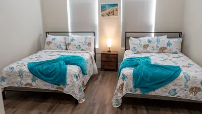 Twin Mermaid Bedroom
Two comfy beds w/ seashell spreads, teal throws & beach art—fun for kids or guests! Cozy lamps in 114 Pike St Unit A, SPI. Walk to beach access for wave-chasing days. Sleep seaside!