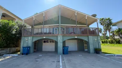 Stunning Mint Duplex w/ Decks & Garage
Iconic seafoam green duplex shines in South Padre! Expansive upper/lower balconies, secure 2-car garage, tropical palms frame the scene. Short walk to beach, prime for SpaceX launch views & island adventures!