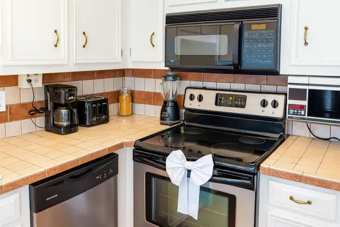 Fully Equipped Coastal Kitchen Haven
Spotless white cabinet kitchen in South Padre beach rental! Shiny black appliances, dishwasher, microwave, coffee maker, blender. Spacious counters, tiled backsplash for easy prep.