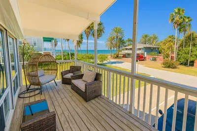 Breathtaking Oceanfront Deck Serenity
Expansive balcony deck in South Padre Island gem! Wicker hanging chair, loveseat, coffee table under shady cover. Direct Gulf views, swaying palms, beach access. Sip cocktails, watch sunsets or SpaceX launches!