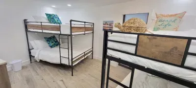 Bright Bunk Room for Groups
Clean, beach‑themed bunk room with four cozy beds, soft lighting, and fresh décor—perfect for families or groups seeking a fun, comfortable space to unwind.