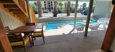 Poolside Beach‑House Escape
Bright, two‑level home featuring a sparkling pool,  tub, outdoor seating and palm‑lined surroundings—an ideal spot for laid‑back coastal living and group vacations.