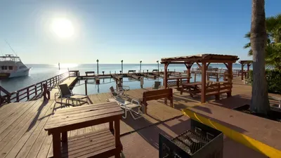 Relax in this serene waterfront retreat featuring open‑air seating, warm sunset views, and peaceful dockside ambiance—perfect for unwinding, gathering, and enjoying calm coastal moments throughout your stay.