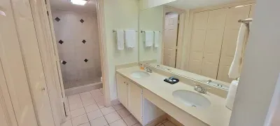 Refresh in this spacious, well‑lit bathroom featuring dual sinks, crisp finishes, and a clean, organized layout. Perfect for getting ready after beach days or winding down in comfort, it offers a bright, functional space within your coastal retreat.