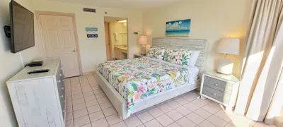Relax in this bright, beach‑inspired bedroom featuring soft natural light, crisp linens, and serene décor. Perfect for unwinding after sun‑filled days, it offers comfort, style, and a peaceful retreat steps from the heart of your coastal getaway.