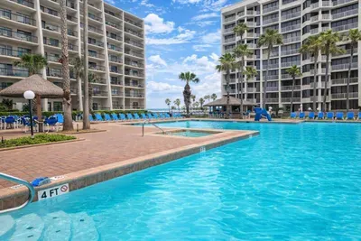 Beachfront resort condo with stunning pool, shaded palapas, and lounge deck—steps from the sand and perfect for families or couples seeking a tropical escape. Enjoy ocean views, water slide, and palm-lined relaxation in South Padre Island.