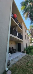 A clean, well‑kept exterior with private balconies, palm‑lined views, and inviting outdoor seating. Guests enjoy a bright, relaxing setting with easy access to shared spaces, creating a comfortable and welcoming atmosphere throughout their stay.