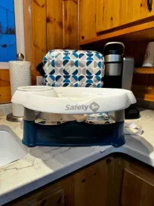 Kid's seat to secure to a chair.