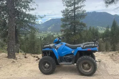 Blue ATV with mountain view.