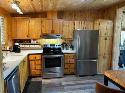 Modern kitchen featuring a refrigerator, stove, oven, microwave, and dishwasher. Enjoy cooking in this well-equipped space