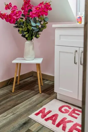 Blush walls, bright blooms, and a little cheeky charm