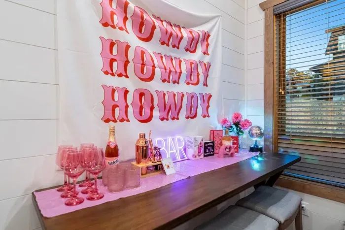 Say howdy to your happy hour corner!  From neon signs to disco shine, this cozy setup was made for giggles and glam