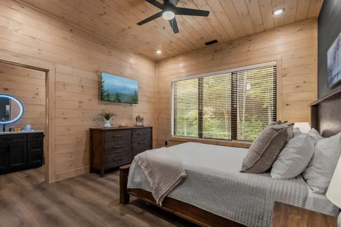 A cozy queen retreat downstairs where style meets comfort, complete with a private full bath to make your stay even more relaxing.