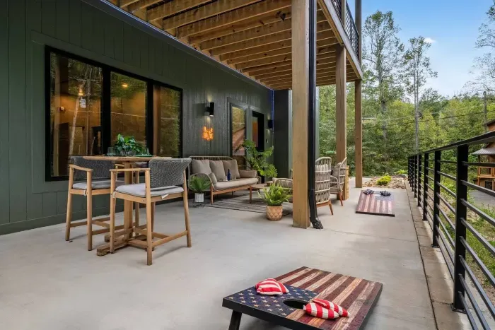 Spacious patio perfect for gathering together — enjoy a friendly game of cornhole or simply relax and take in the peaceful sounds of the mountains.