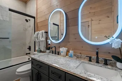 bunk bed room bathroom with a double sink.