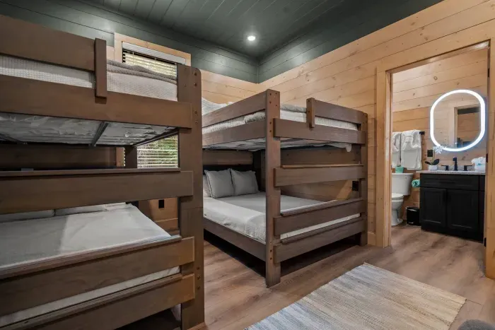 Where style meets practicality: queen bunk beds and a private full bath.