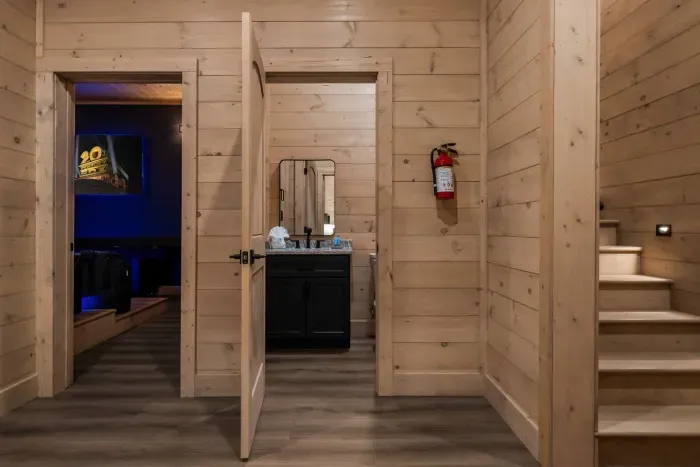 This half bathroom is located downstairs outside the theater room. 