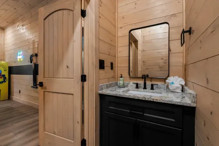 This half bathroom is located outside the indoor pool.