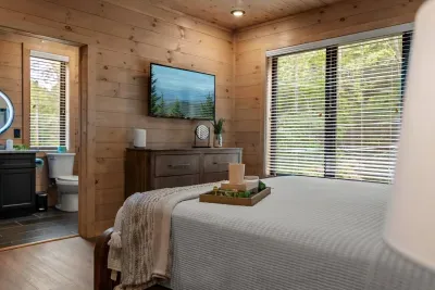 Rest comfortably in this inviting bedroom featuring warm wood tones, a plush king bed, and your own private full bath for added comfort and convenience.