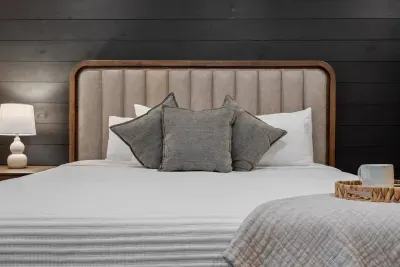 The dark shiplap wall and layered textures add a touch of mountain luxury to your stay.
