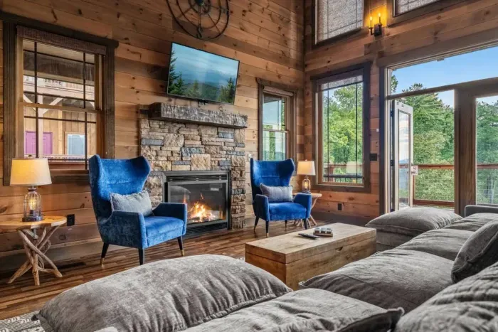 Big couch, warm fire, and mountain vibes… this living room has it all.