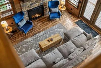 Looking down from upstairs, the living room opens up with soaring ceilings and cozy charm.