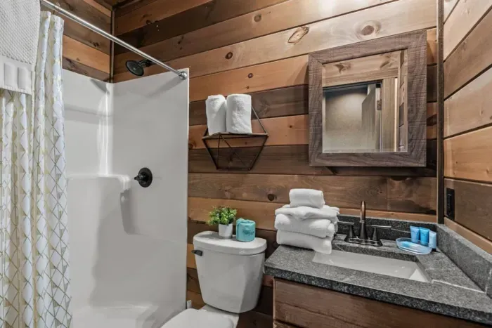 Conveniently located off the pool room, this full bathroom features a shower, sink, and toilet for easy access while swimming or lounging. Stocked with starter essentials, it ensures comfort without ever having to leave the fun.