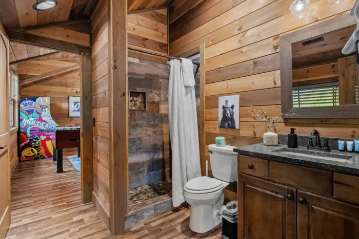 This full bathroom connects both Bedroom 3 and the upstairs entertainment space, offering convenience and privacy. Thoughtfully designed, it provides everything guests need to refresh and relax.