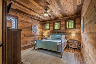 Bedroom One offers a spacious king-size bed, private full bathroom, TV, and closet.
