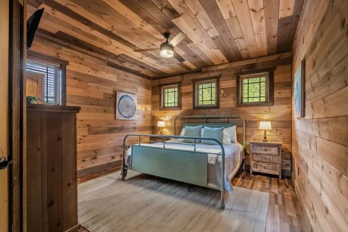 Bedroom One offers a spacious king-size bed, private full bathroom, TV, and closet. 