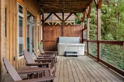 Relax in the hot tub under the soft glow of string lights, surrounded by mountain views. With plenty of seating and a cornhole setup, this space is made for both cozy nights and fun afternoons.