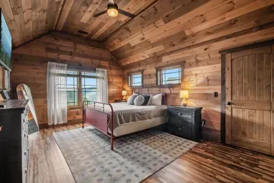 This stylish retreat features a king-size bed, a tall floor-length mirror, a closet with a small safe for valuables, and a flat-screen TV.